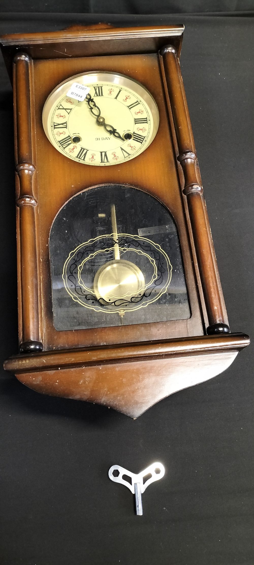 Lot 297: 31 day Mid Century pendulum clock with key...