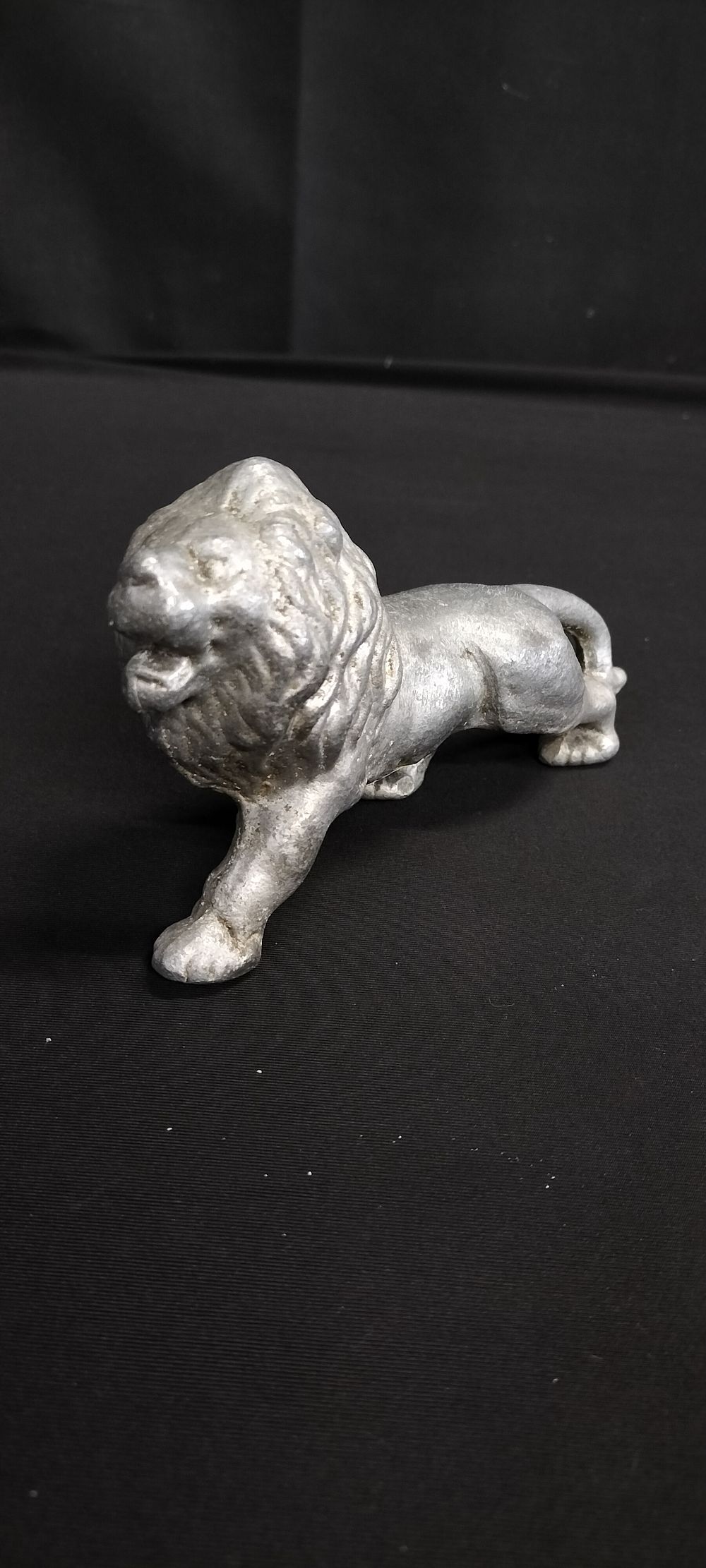 Lot 311: Cast metal figure of a lion. Measures approx...