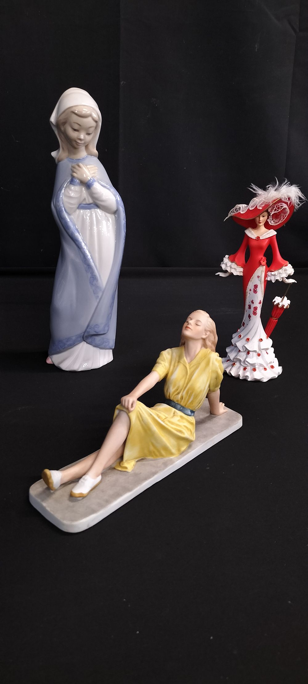 Lot 313: Three figurines. Nao of a young girl wearing...