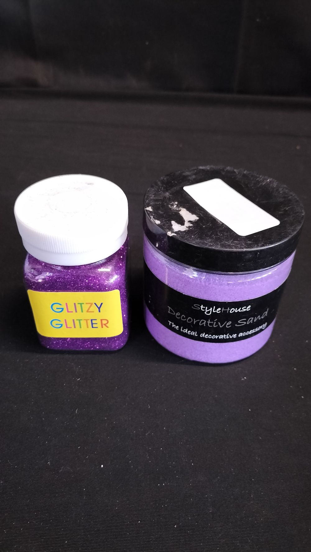 Lot 580: Tub of purple glitzy glitter and purple decorative...