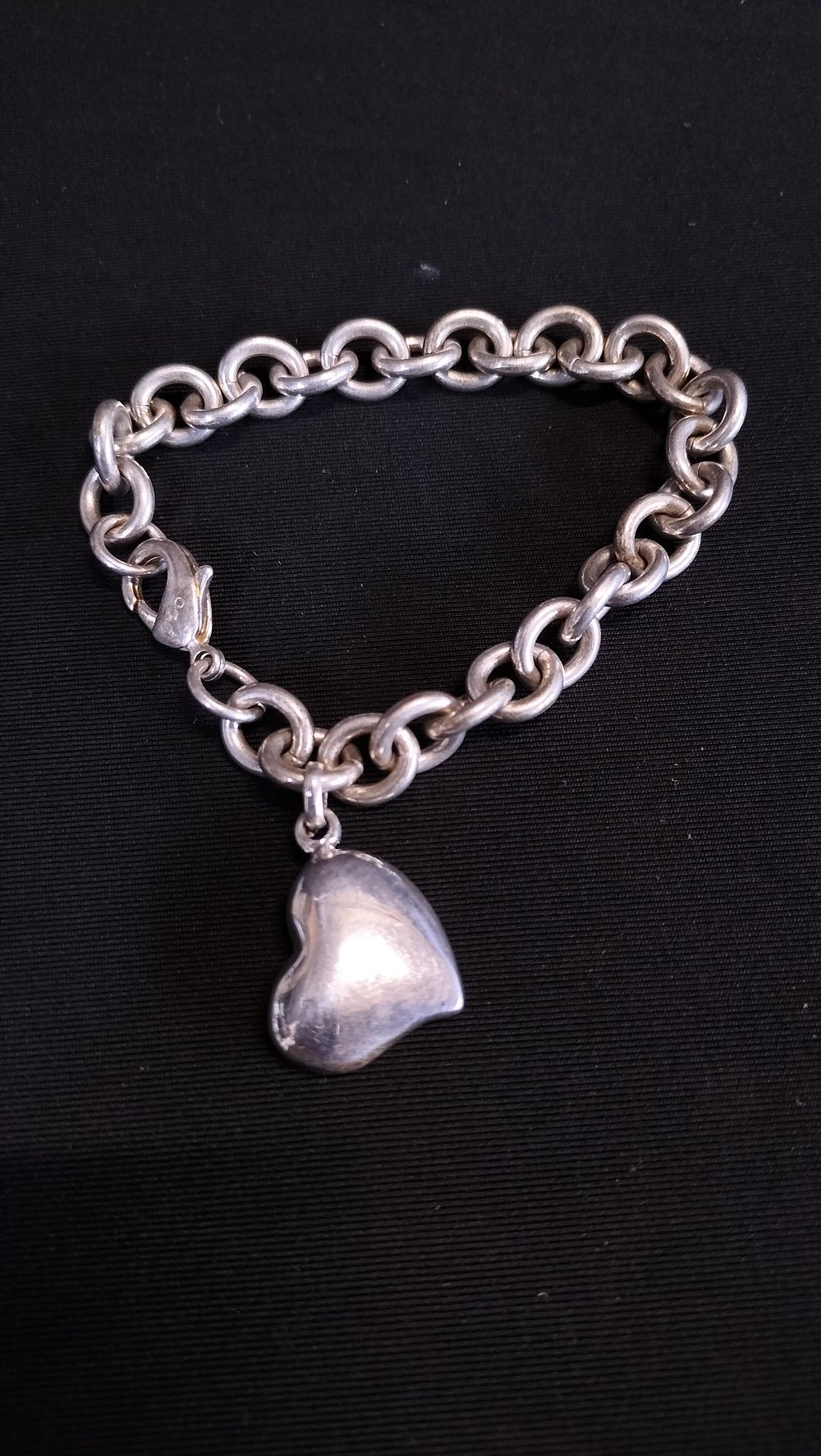 Lot 624: Sterling silver link bracelet with heart charm.