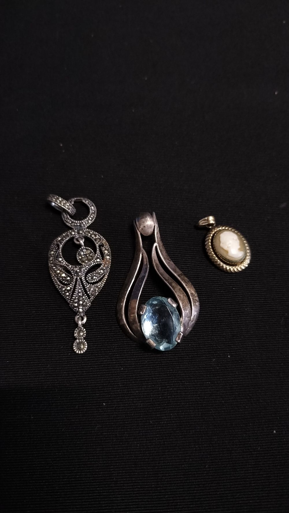 Lot 691: Three sterling silver pendants with various settings 