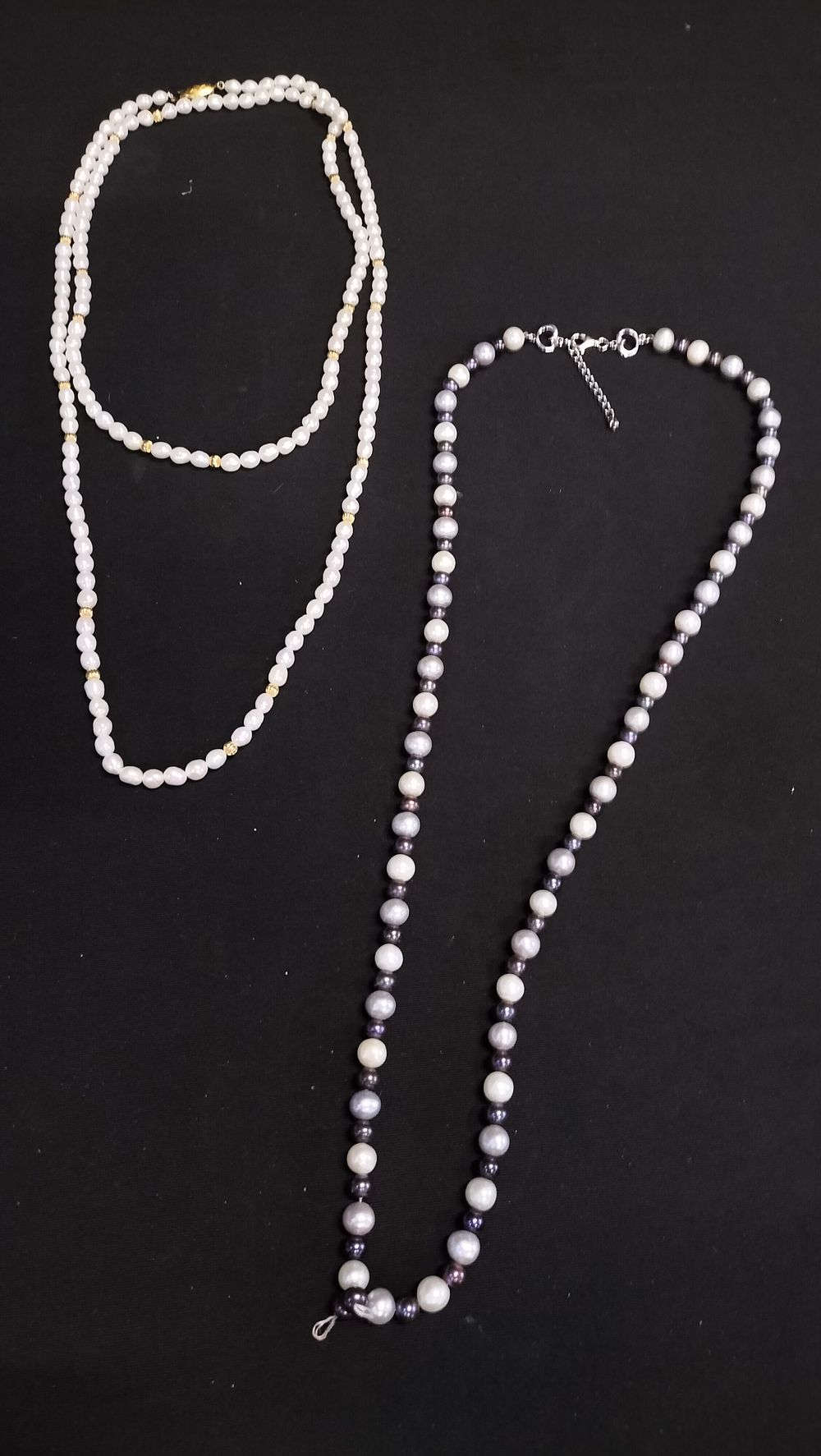 Lot 701: Two pearl necklaces with gold plated silver clasp,...