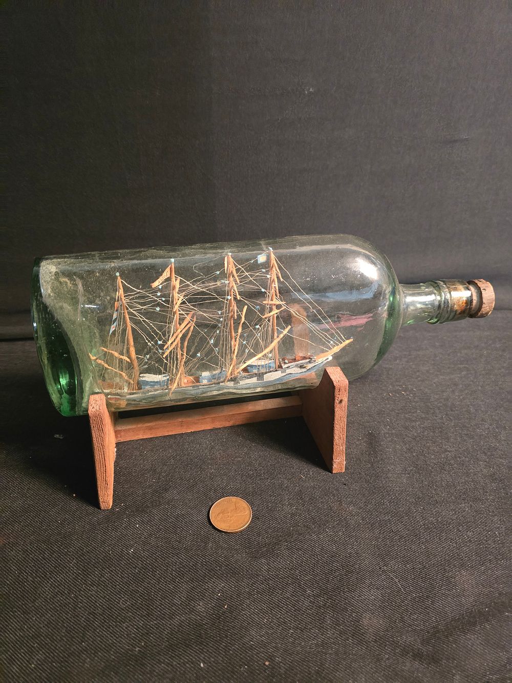Lot 675: Vintage ship in a bottle with stand