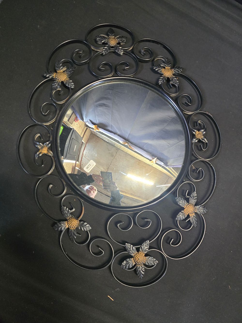 Lot 643: A cast metal floral design mirror