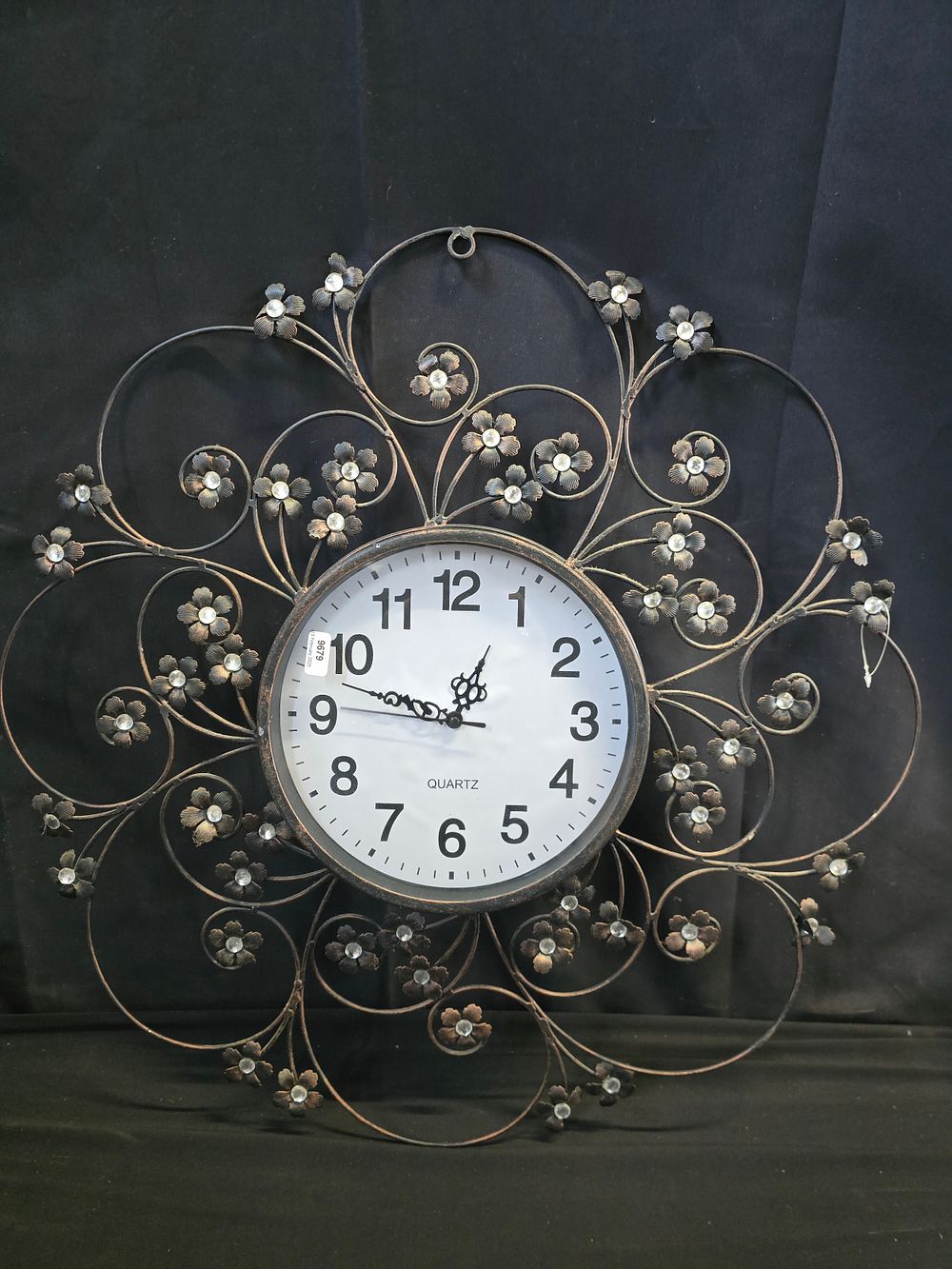 Lot 644: Cast metal floral design wall hanging clock