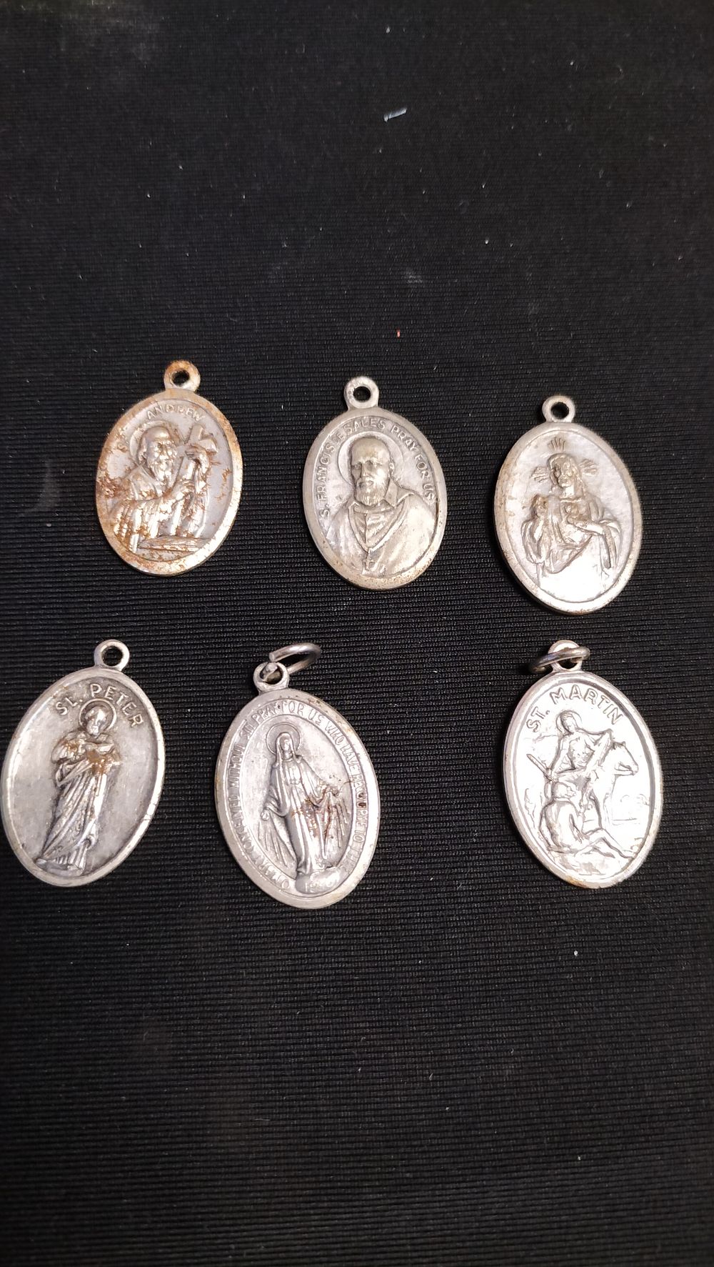 Lot 554: Five religious pendants including Saint Andrew, Saint Peter...