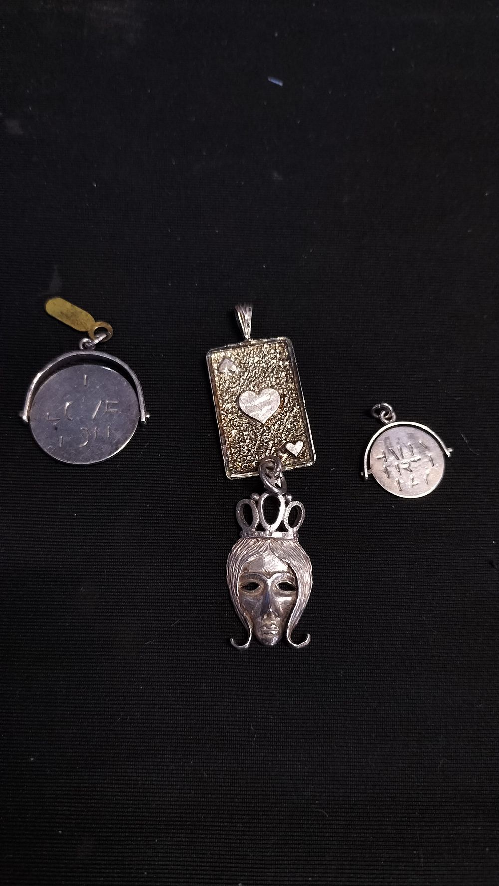 Lot 555: Four vintage pendants including sterling silver