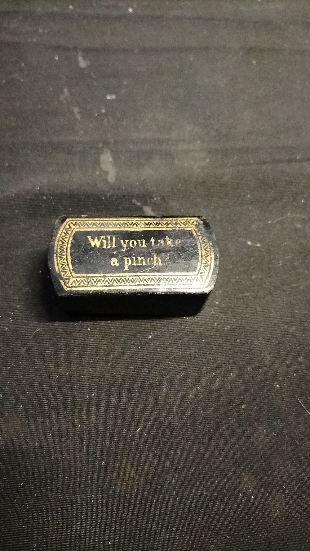 Lot 569: Ebony and gold gilt snuff box 