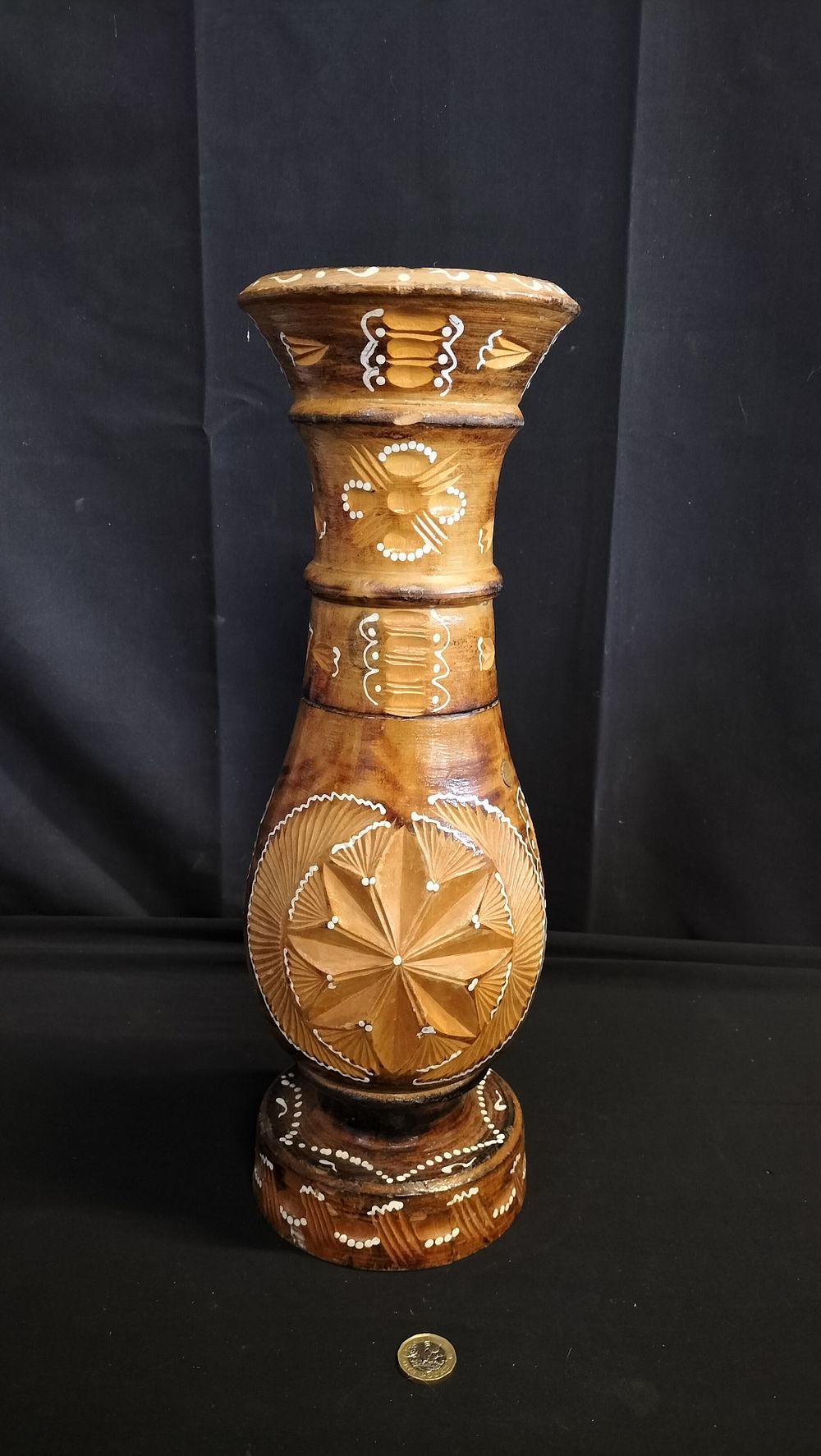 Lot 612: Solid Wood carved vase with white decoration 