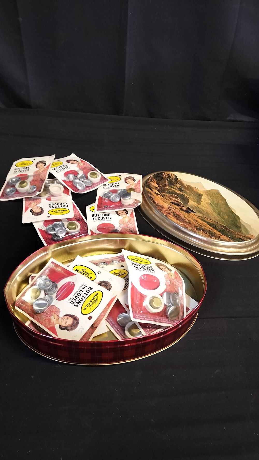 Lot 693: Tin containing 13 packs of button covers 