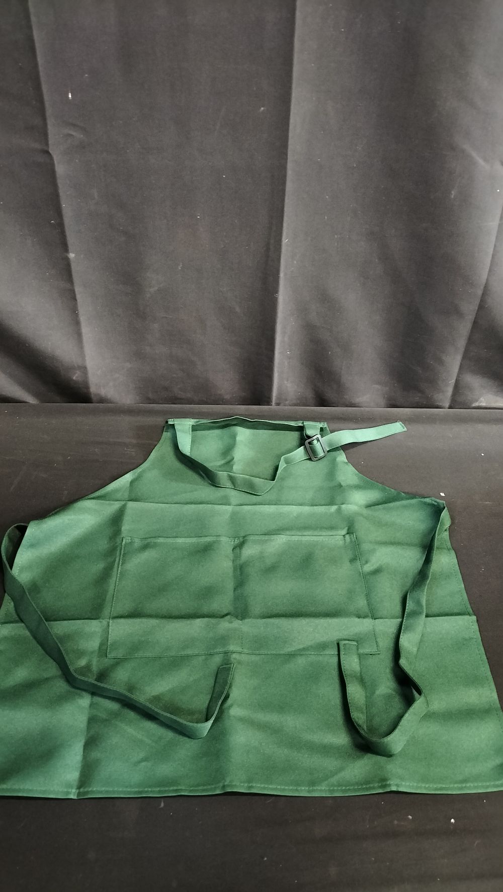 Lot 729: Three children's green apron with pocket 