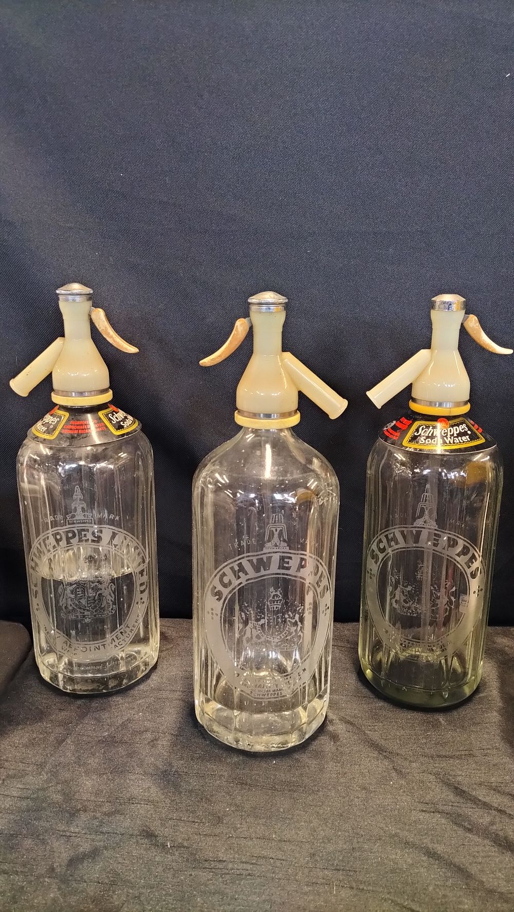 Lot 659: Three Schweppes glass soda syphons 