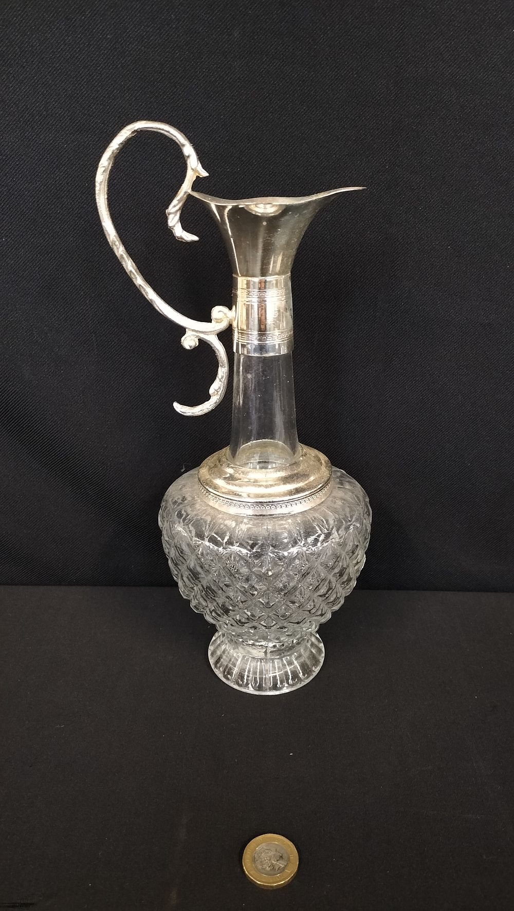 Lot 716: Cut crystal decanter with silver plated top. Measures...