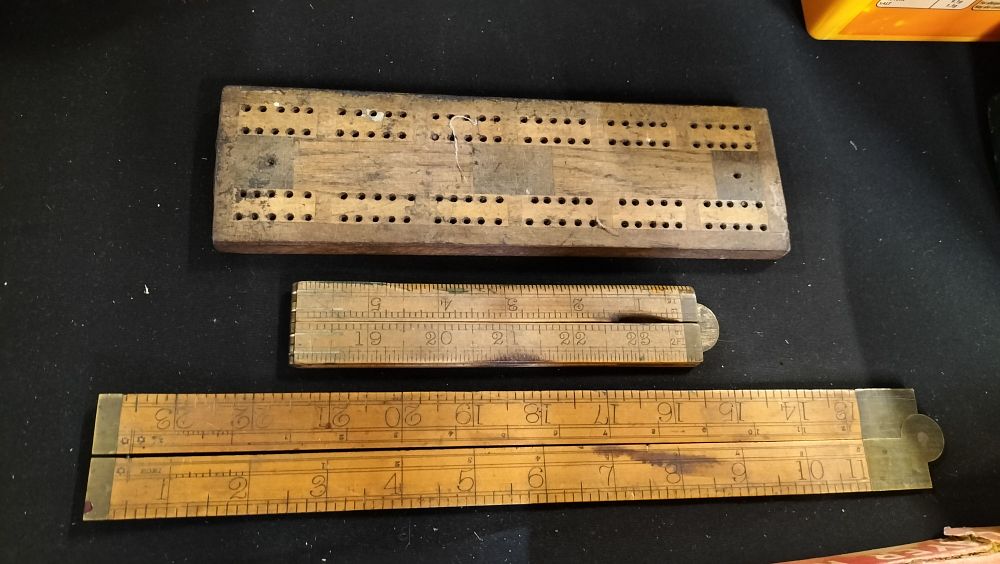 Lot 800: Two vintage folding rulers and a wooden peg...