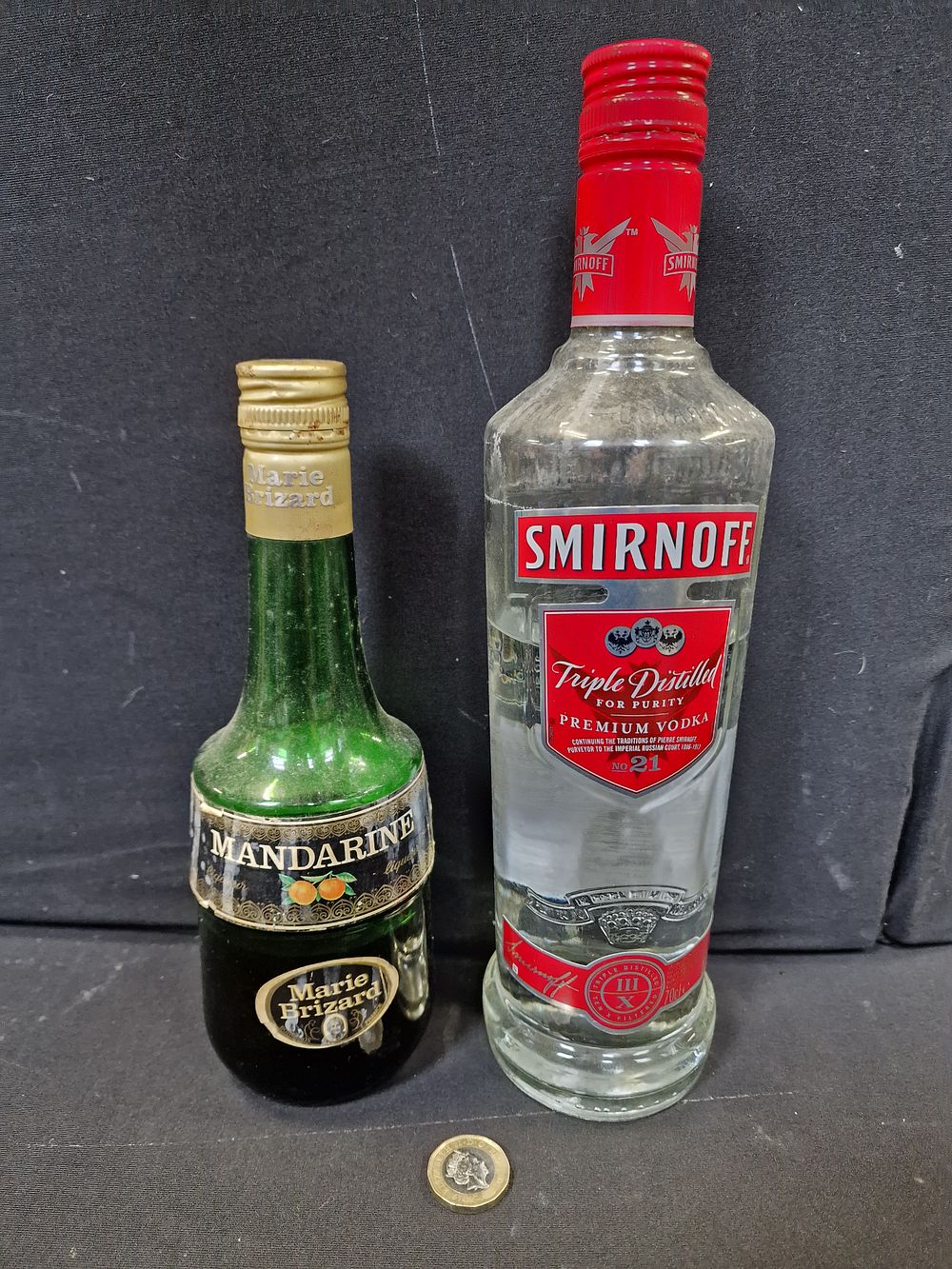 Lot 219: Smirnoff Vodka and Mandarine Liqueur. Both have been opened COLLECTION ONLY