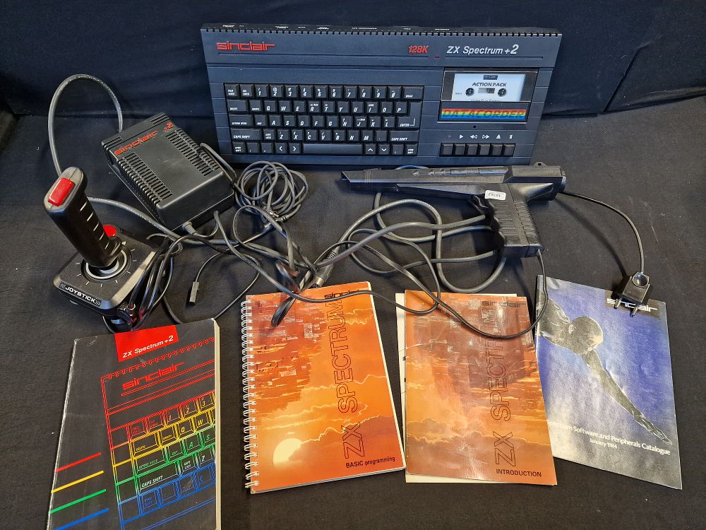 Lot 386: Vintage Sinclair ZX Spectrum +2 128k Intergrated Micro Computer with Power Supply Unit, Joystick, Gun and Manuals. Tested for Power. Has European Plug.