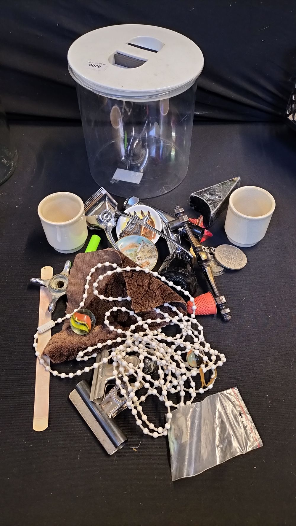 Lot 680: Storage tin containing various items 
