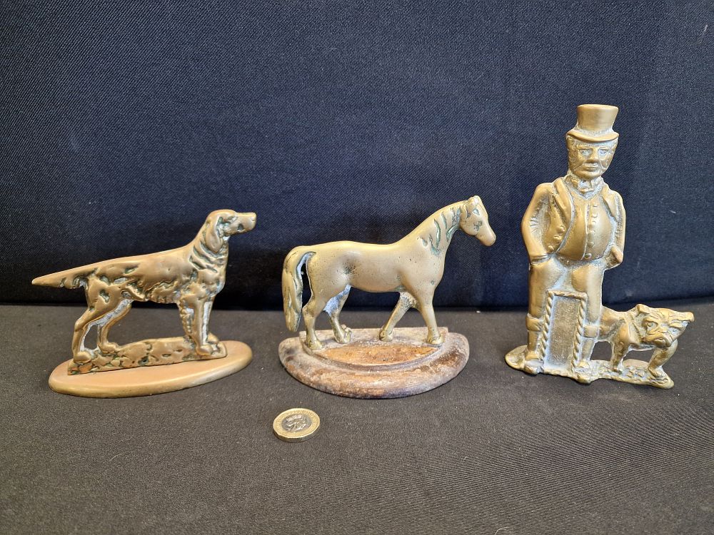 Lot 565: Three Brass Doorstops