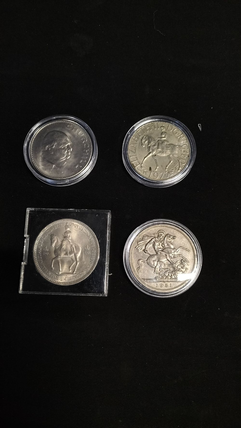 Lot 768: Four vintage coins including Churchill, 1951, 1977, and...