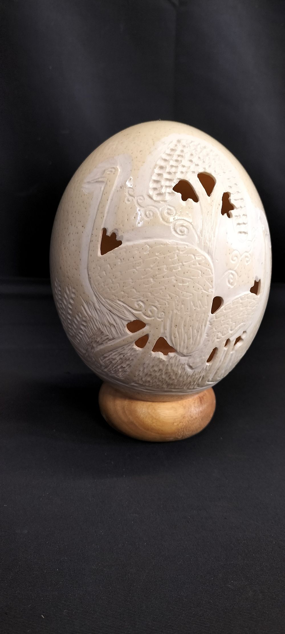 Lot 196: Carved Ostrich Egg on Wooden Base. Measures approx...