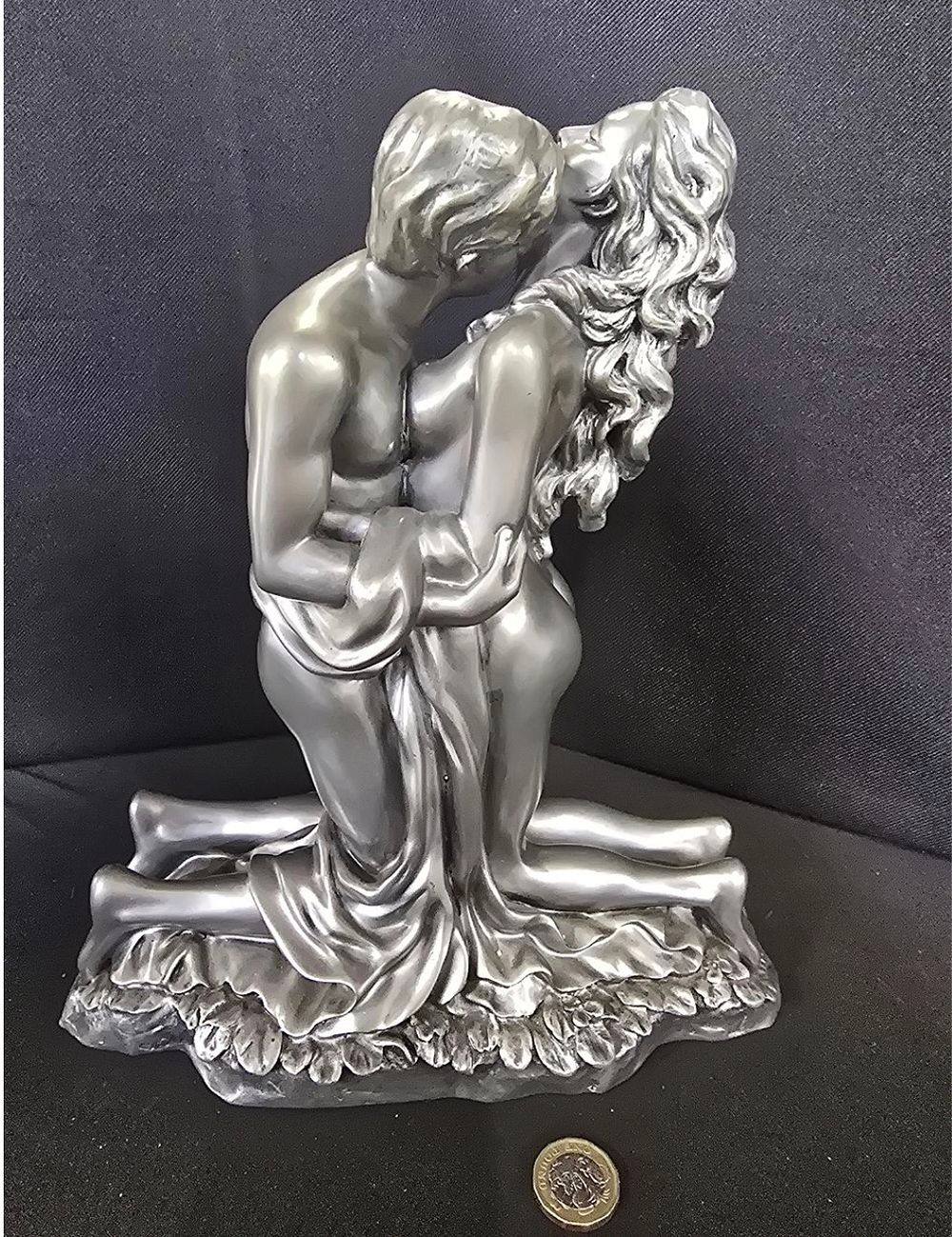 Lot 283: A large resin figure of an embracing couple....