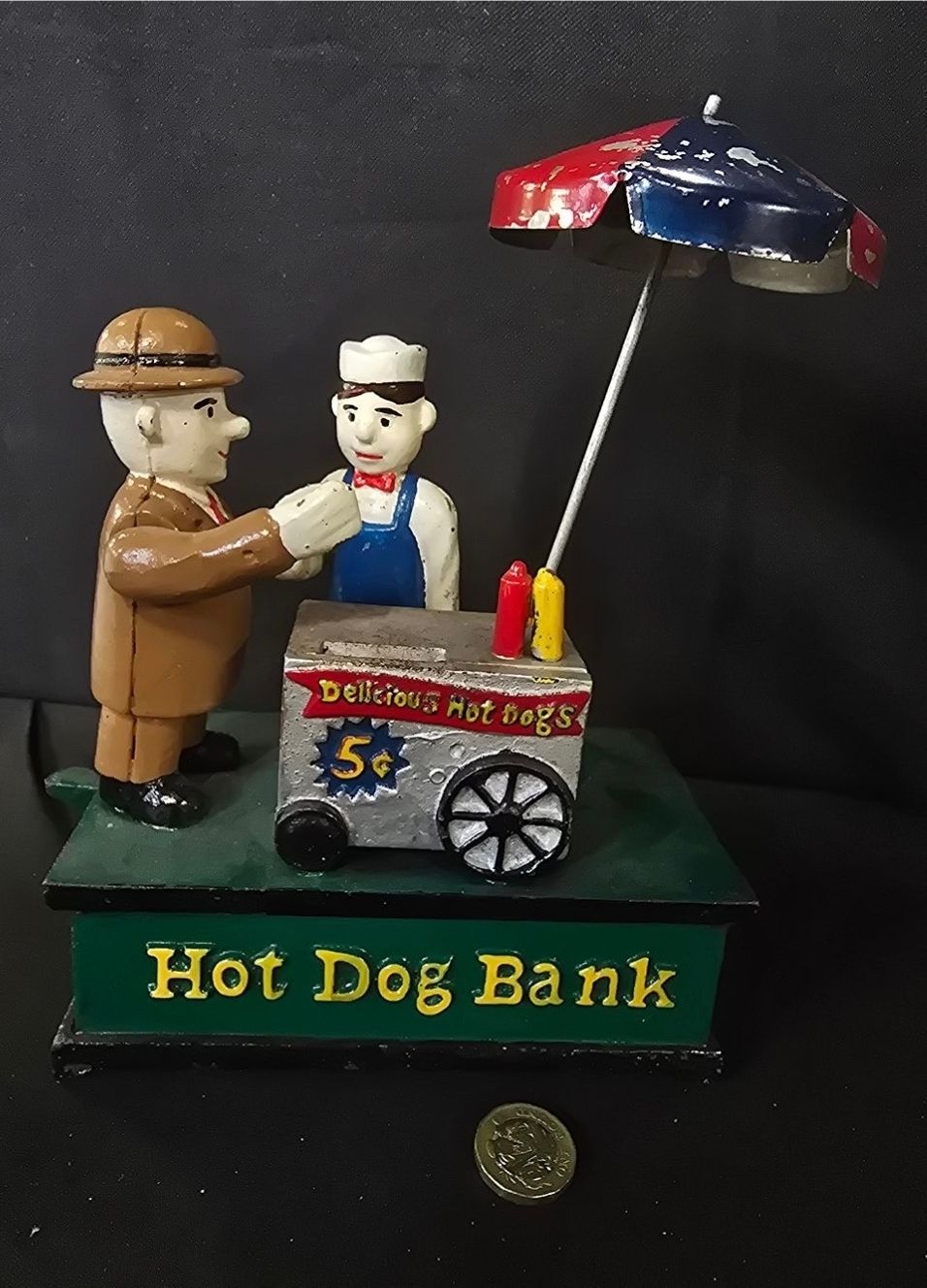 Lot 285: Hot dog vendor cast iron money box. Working....