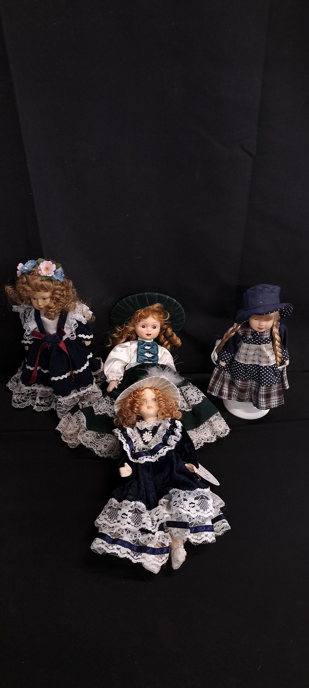 Lot 292: Four Various Sized Porcelain Dolls, Two on Stands....