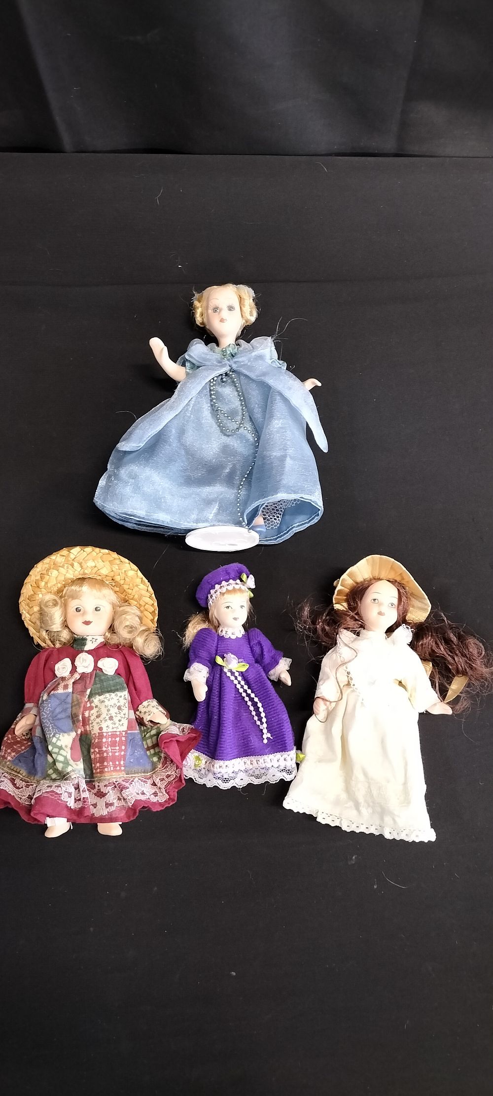 Lot 294: Four Small Porcelain Dolls