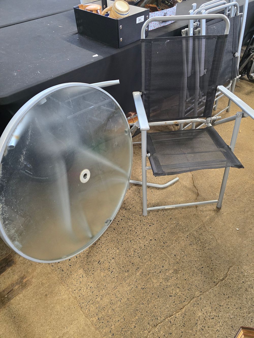 Lot 253: Circular glass garden table 80cm Dand four folding chairs, with grey parasol