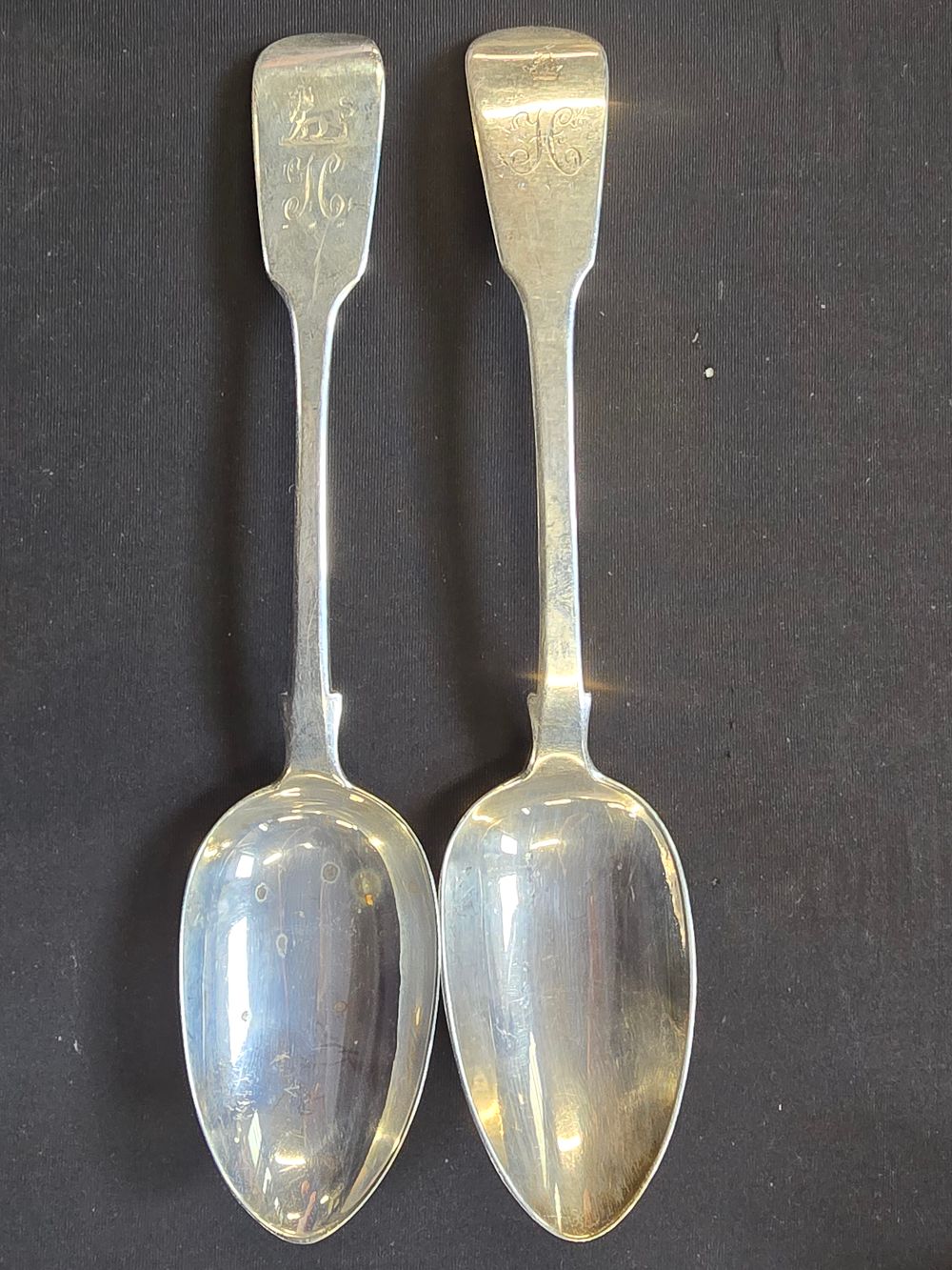 Lot 283: Two sterling silver hallmarked serving spoons with monogram. 155g approximately