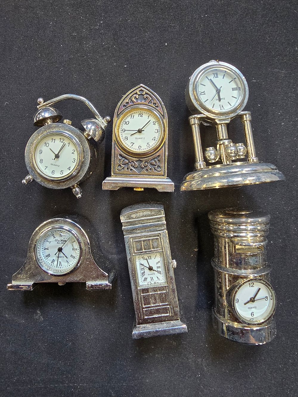 Lot 782: A selection of six mini white metal clocks