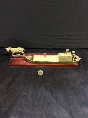 Brass canal boat, a horse and a man mounted on a wooden base. In good condition for a vintage