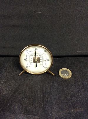 Quirky Retro thermometer and hygrometer. The outer scale is in degrees Celsius and measures