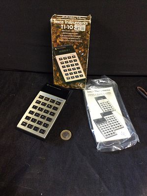 Texas Instruments TI-1025 electronic calculator. In its own box