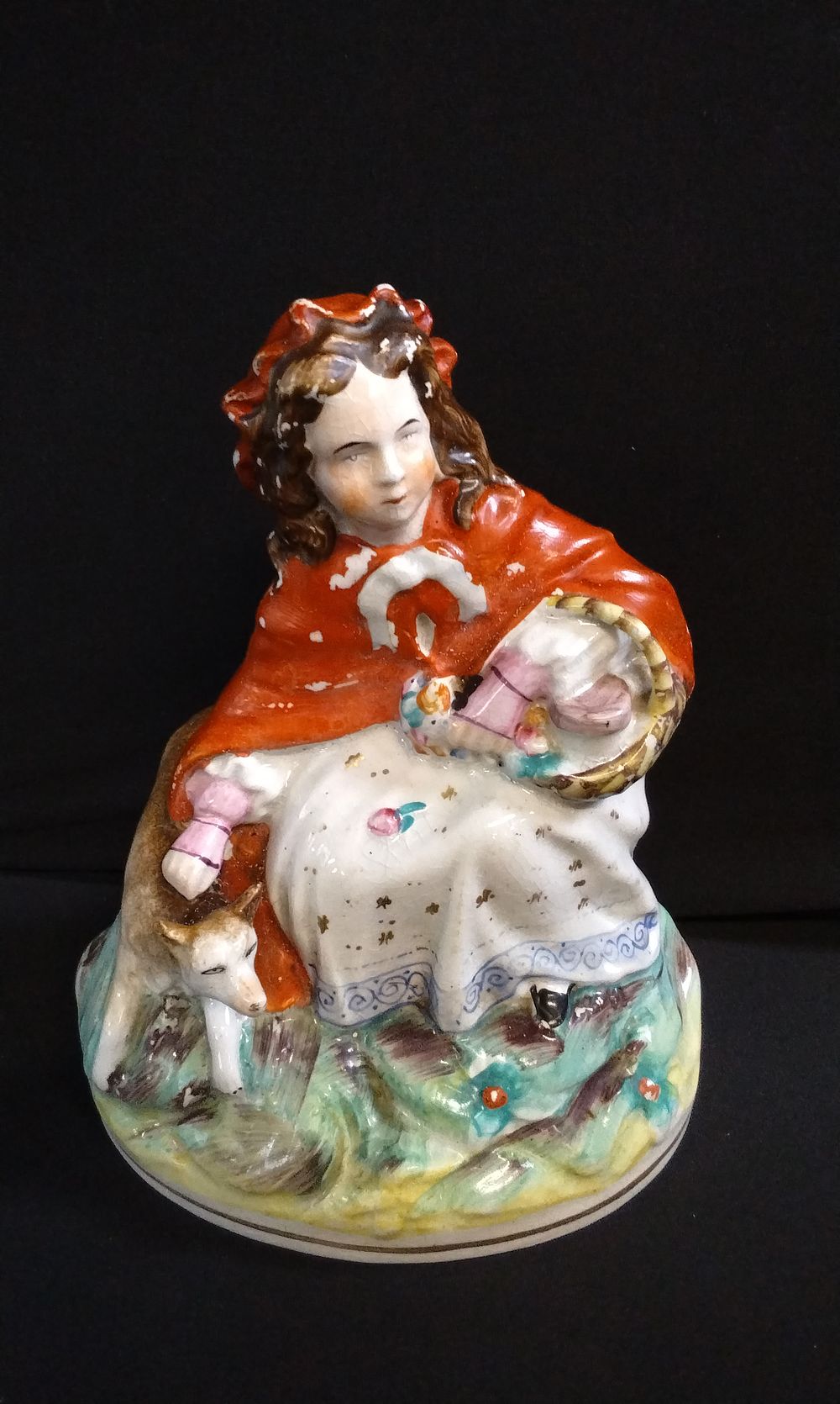Lot 411: Staffordshire figure of Little Red Riding Hood.