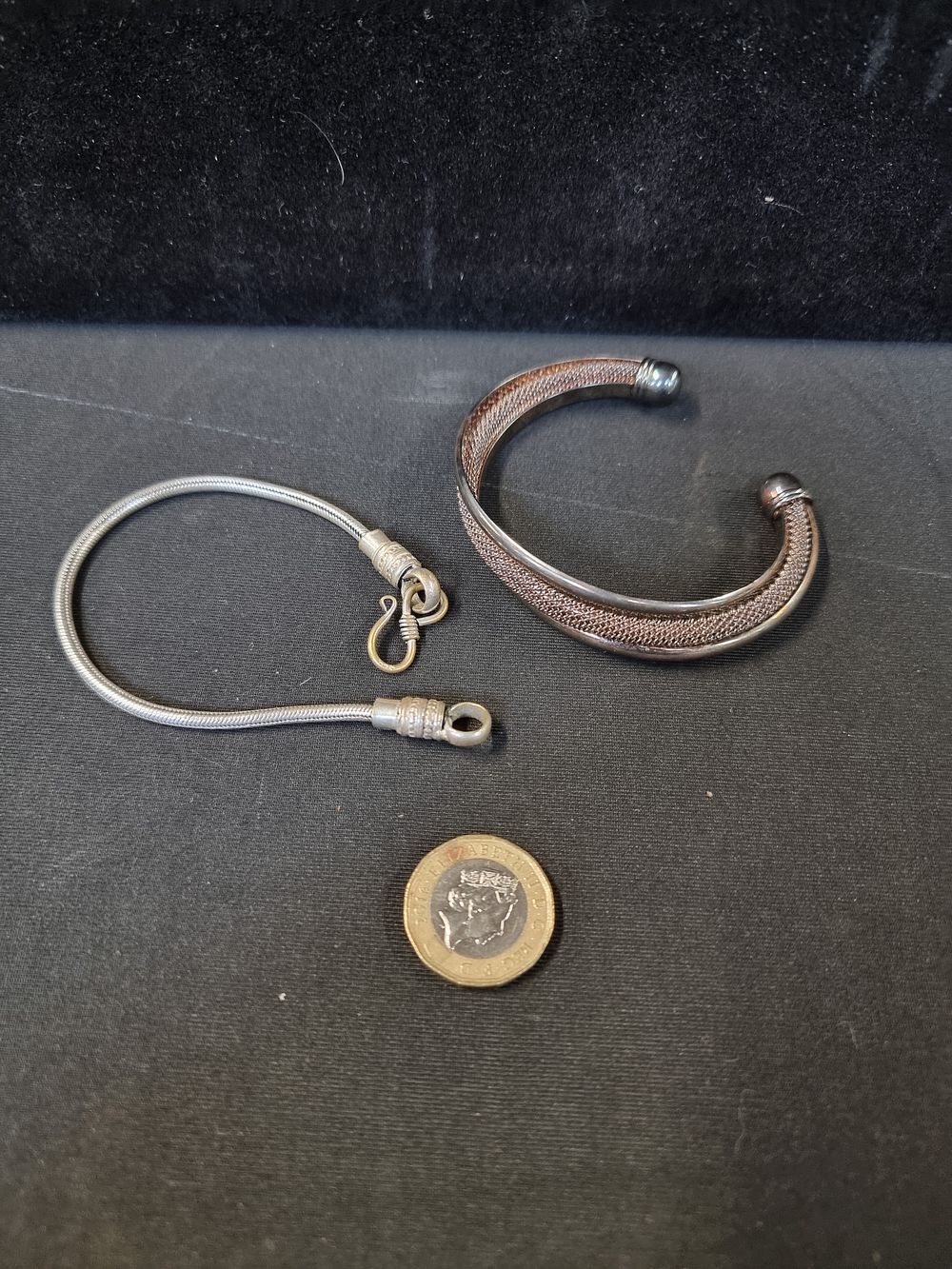 Lot 728: 2 bracelets,  one silver and copper tone cuff bracelet and a silver tone snake bracelet