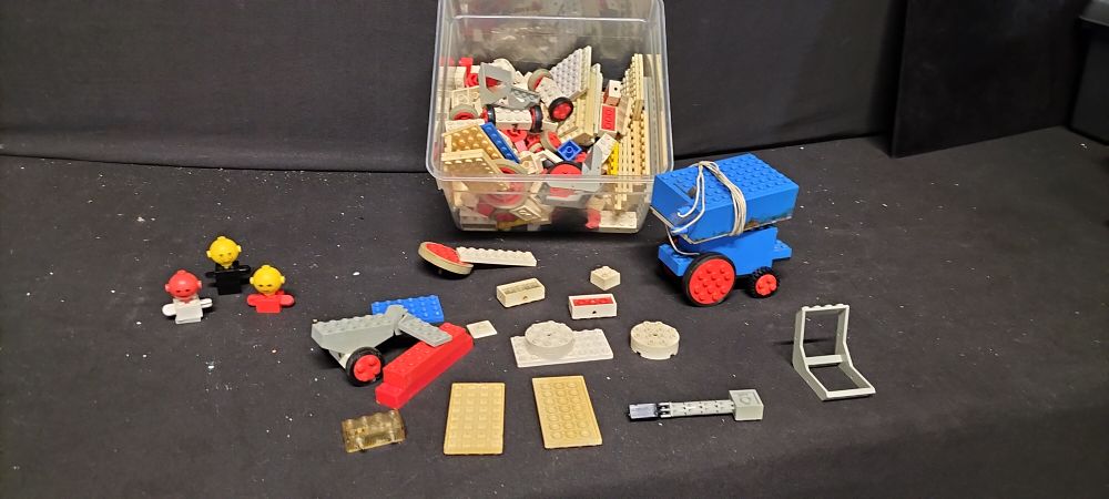 Lot 785: Box of Vintage Lego Pieces Including wheels, Different Sized Plates and Lego System Homemaker Torsos