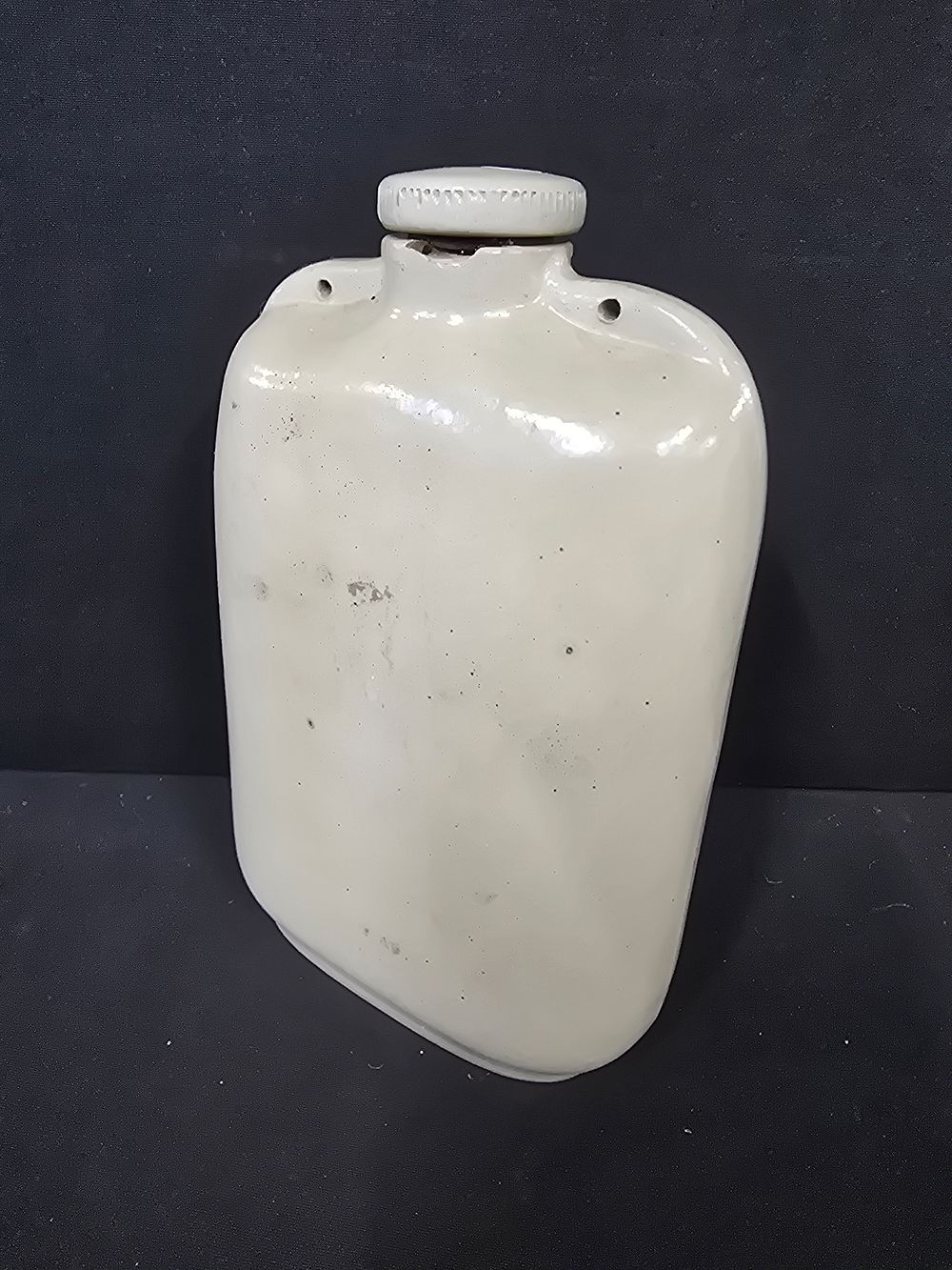 Lot 791: A vintage ceramic foot water/ hot water bottle