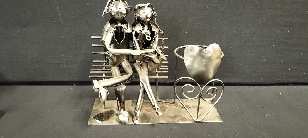 Lot 317: Metal Art Wine Bottle Holder depicting Couple on a bench