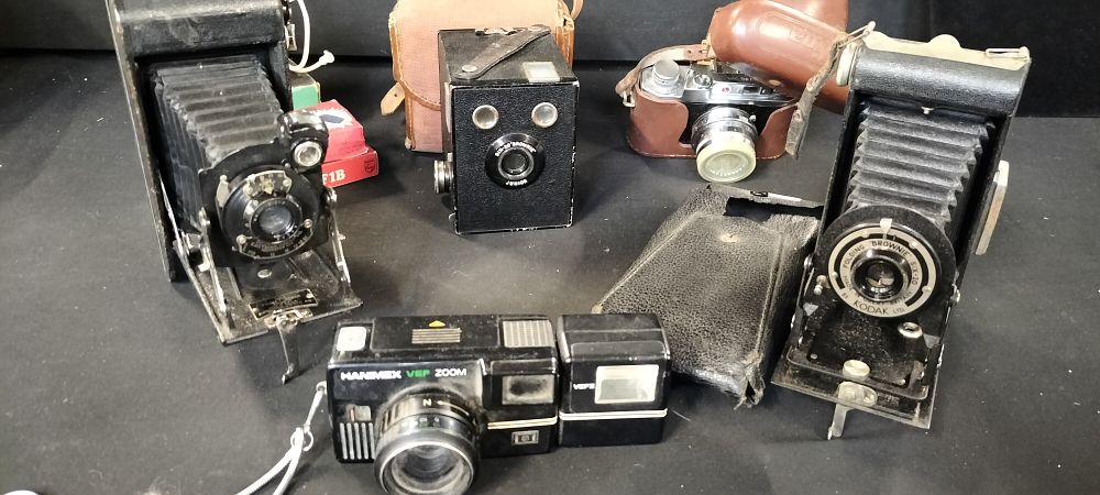 Lot 351: Lot of Five Vintage Cameras Including Kodak Box Brownie, Folding Brownie, Halina and a Ferrania Flash Unit