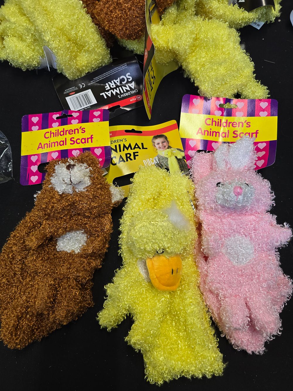 Lot 468: Nine brand new kids animal scarves.