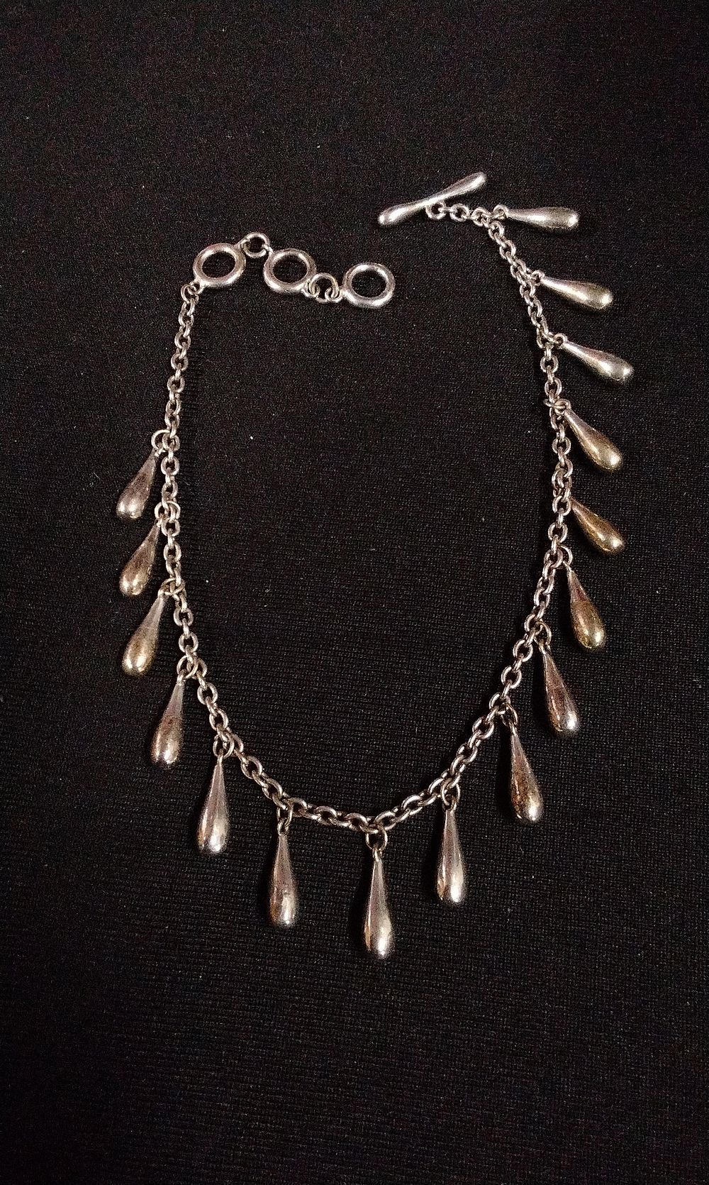 Lot 343: Sterling Silver Teardrop Charm Bracelet