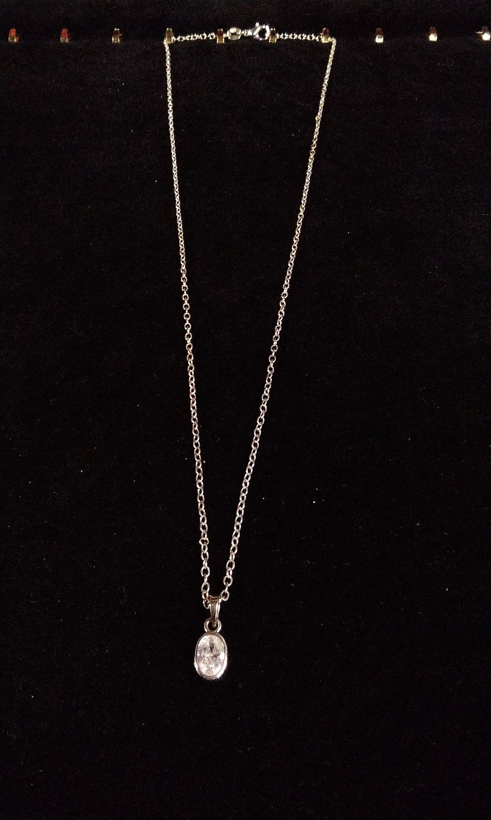 Lot 369: Sterling Silver Necklace with Clear Oval Pendant and Gold Accents