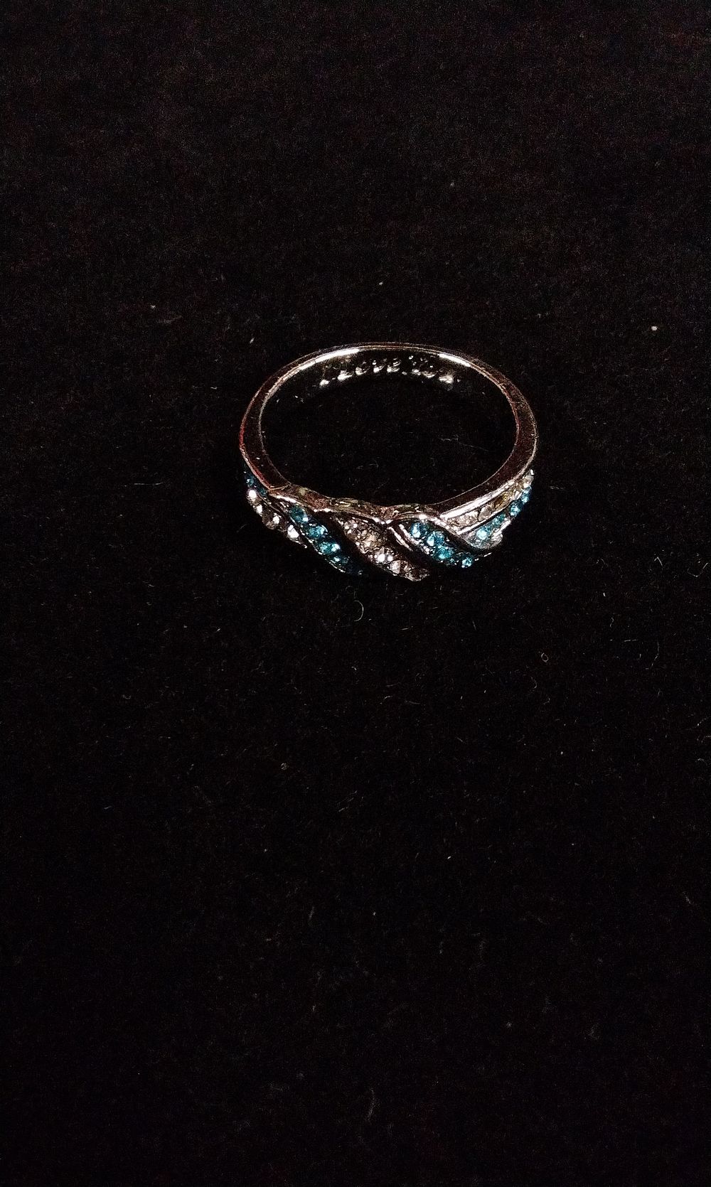 Lot 372: A Silver-Tone Ring with Intertwined Blue and Clear Stones. And I Love You on the Inside