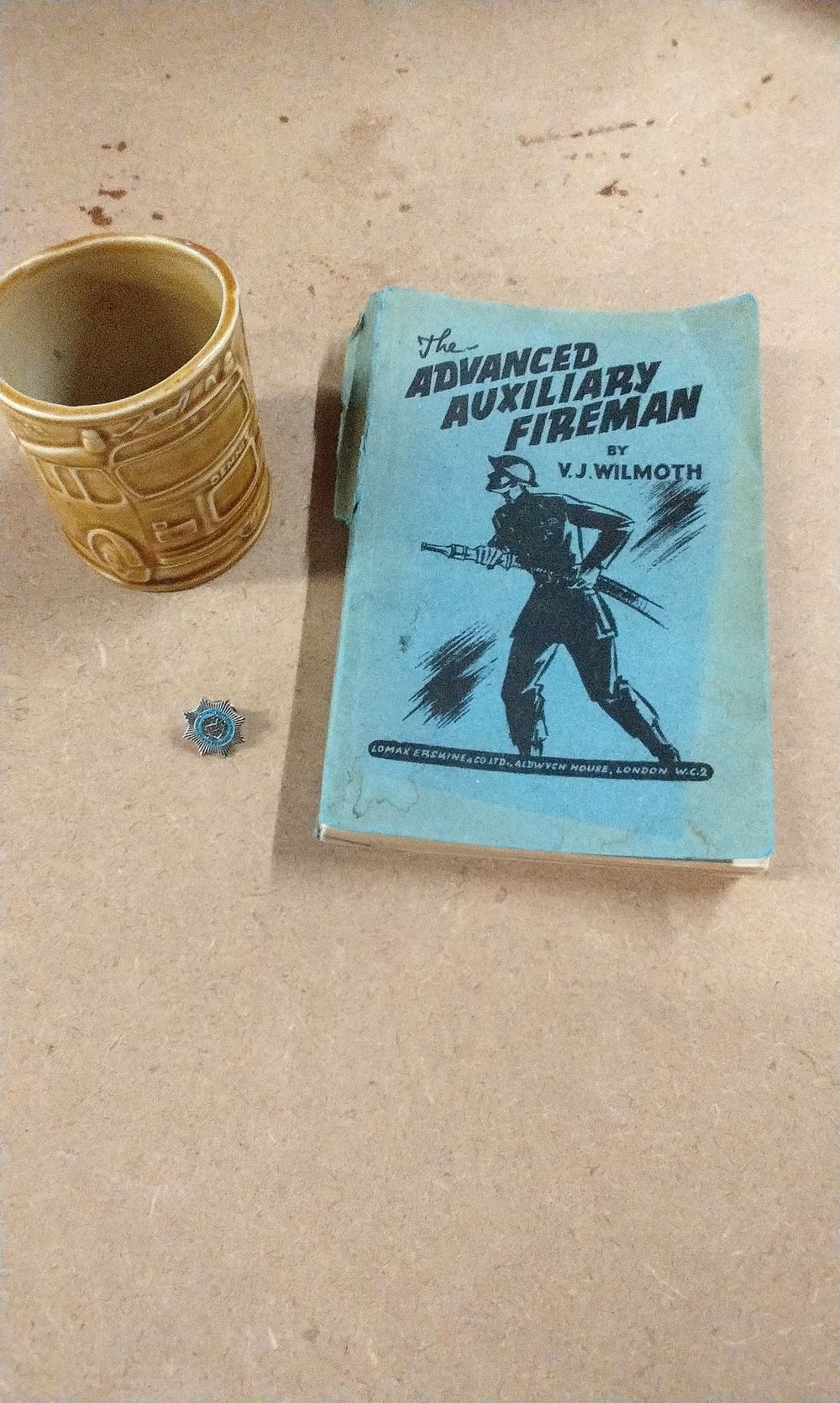Lot 179: An Auxiliary Fireman Book, A Mug and a Fire Brigade Badge