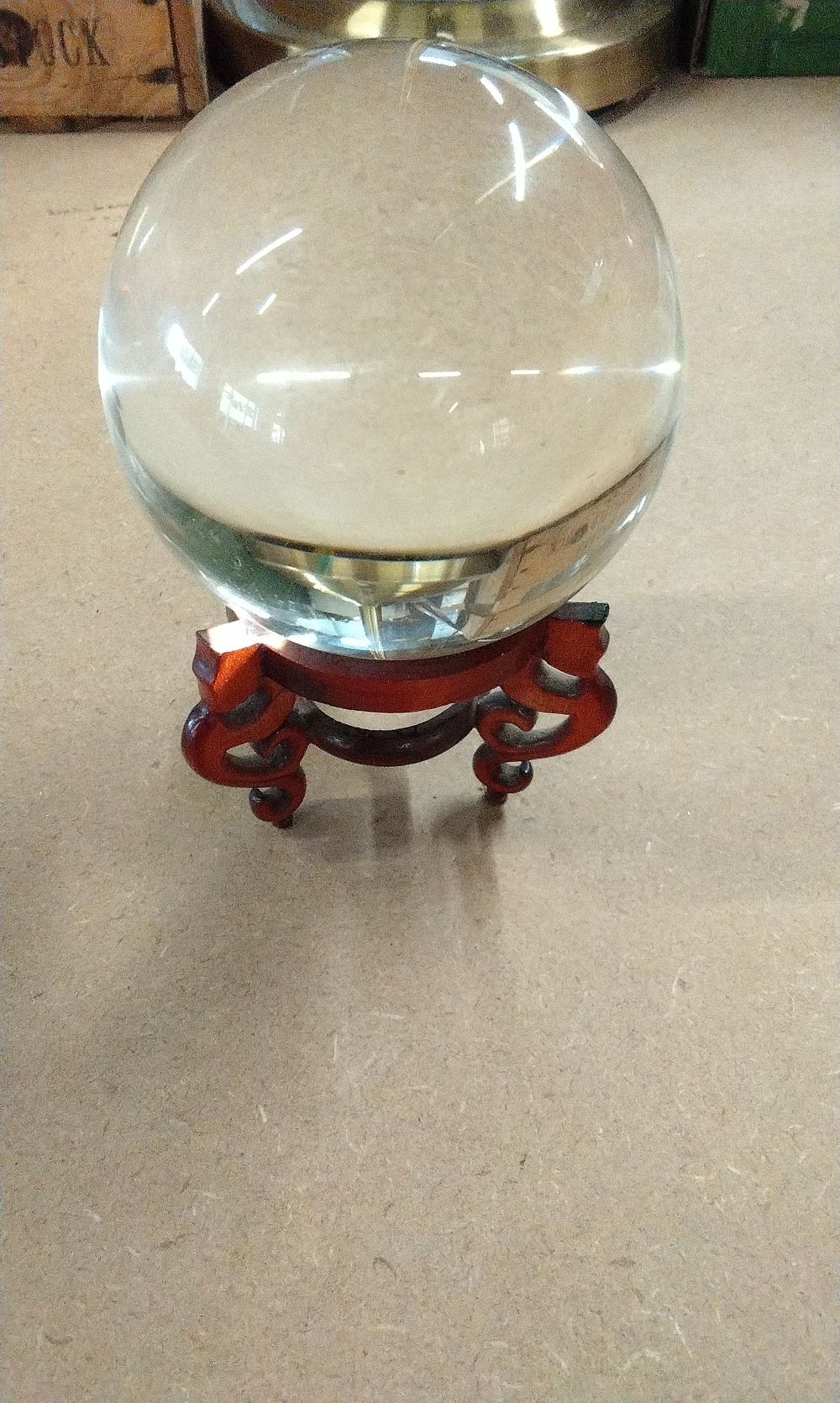 Lot 182: A Large Clear Glass Sphere with Wooden Stand