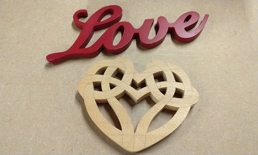 Lot 192: A Red Wooden 'Love' Decorative Sign and Celtic Love Knot