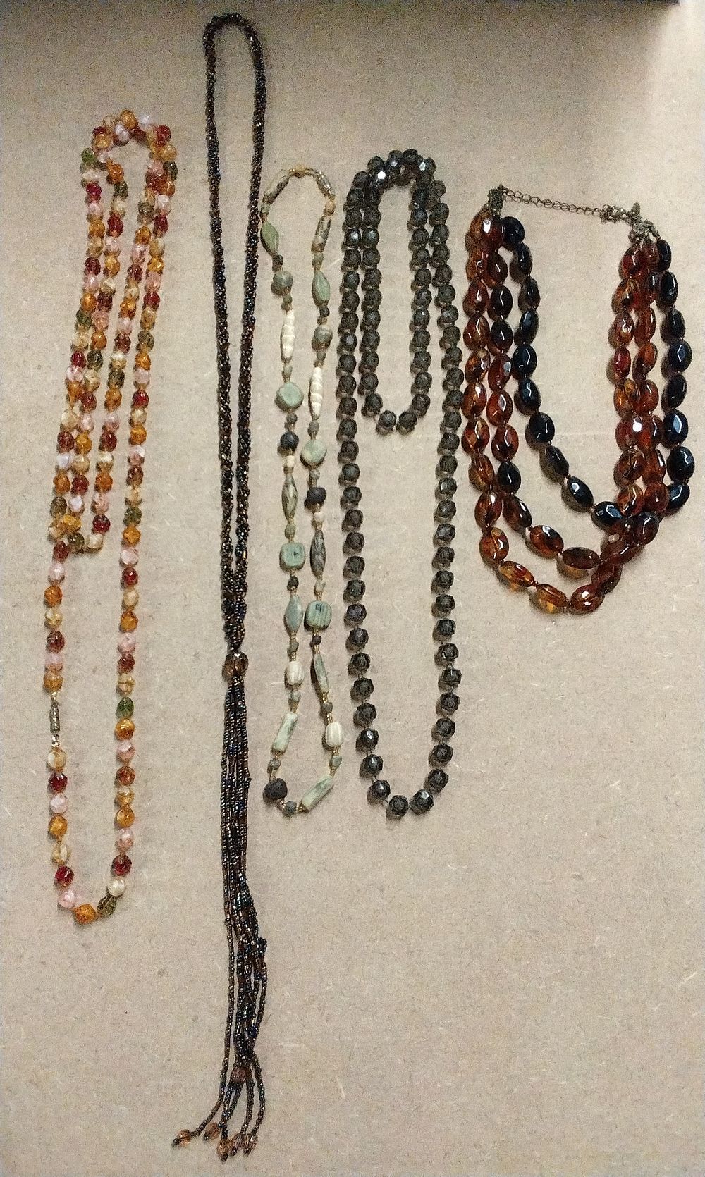 Lot 197: Five Multi-Strand Brown and Black Beaded Necklaces