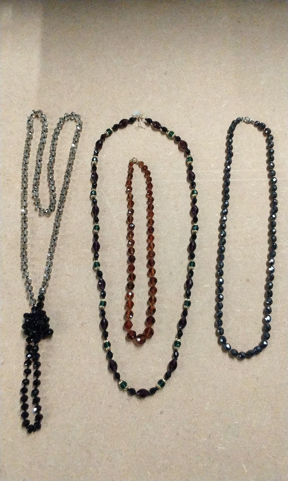 Lot 212: Long Silver/Grey Faceted Bead Necklace with Black Tassel